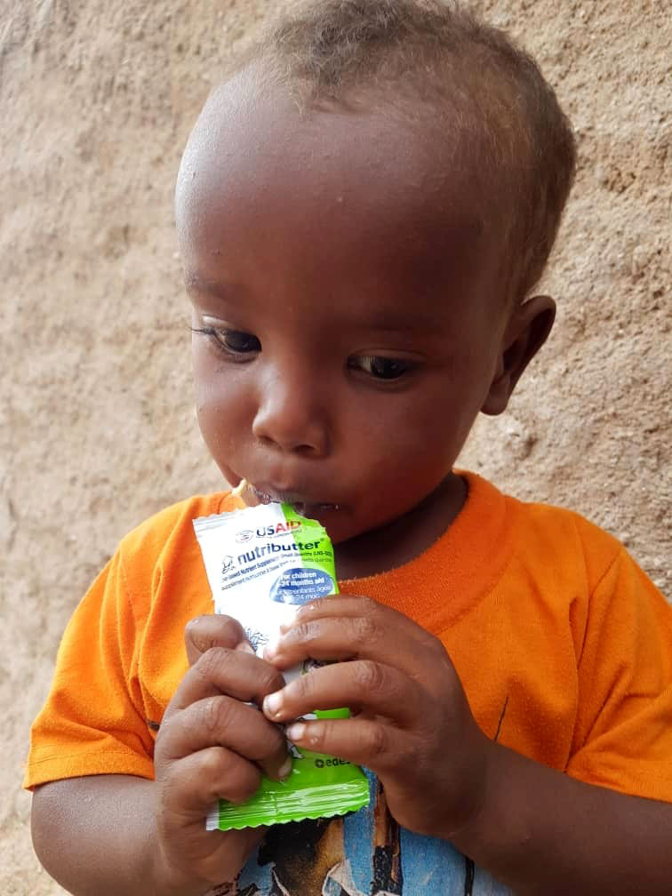 Child eating from a Nutripacket